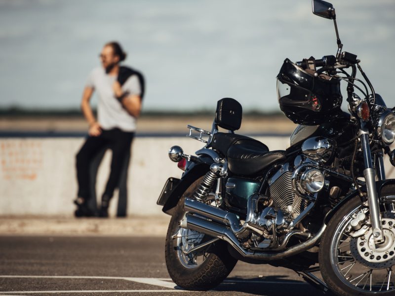 selective focus of chopper motorcycle and biker on background