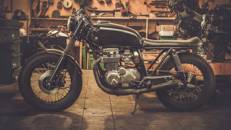 Vintage style cafe-racer motorcycle in customs garage